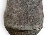 a close up of a stone vase with writing on it