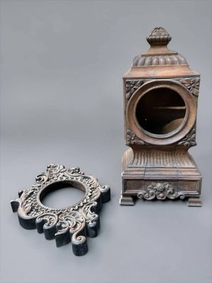 a small clock and a small mirror on a table