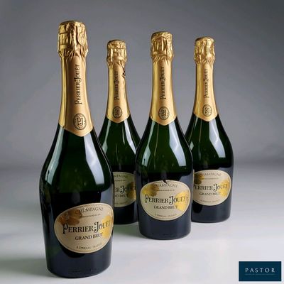 four bottles of champagne are lined up on a table