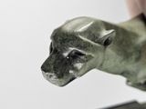 a small statue of a dog that is on a table