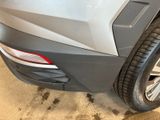 a close up of a car ' s rear bumper and tire