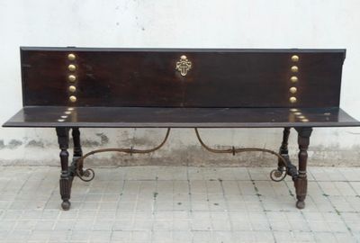 a wooden bench that is sitting on a brick floor