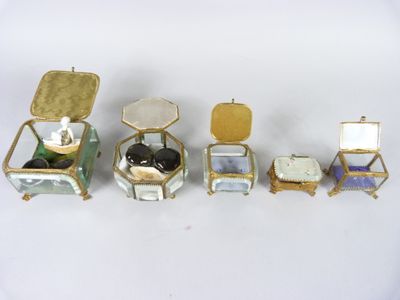 four small boxes with rings and a ring box on top of them