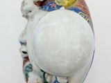 porcelain figurine of a group of dogs sitting on top of a bowl