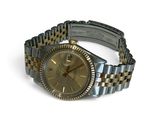 a watch that is sitting on a bracelet on a white surface