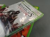 three video games are stacked on top of each other on a table
