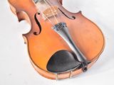 a violin that is sitting on a white surface