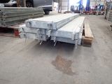 a large pile of steel beams in a warehouse