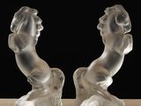 pair of crystal figurines of a woman and a horse on a table