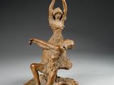 an image of a statue of a woman sitting on top of a rock