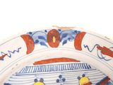 a blue and white plate with a yellow duck on it