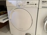 a white washer and a dryer in a small room