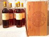 several bottles of wine are lined up in front of a wooden box