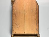 a wooden wall hanging with a birdhouse on it