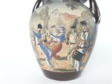 a vase with a picture of a band playing on it