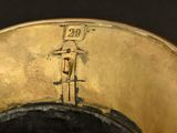 a close up of a gold vase with a clock on it