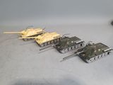 several toy tanks are lined up in a row on a table
