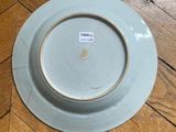 a plate on the floor with a sticker on it