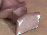 a clay sculpture of a man ' s head on a table