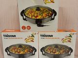 three boxes of tristar frying pans sitting on a table