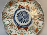 a blue and white plate with a flower design on it