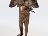 bronze figurine of an angel holding a bird on a pedestal