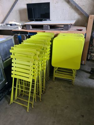 a lot of yellow chairs and a television in a room