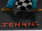 a figurine of a man with a soccer ball on a black surface