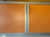 an orange cabinet in a room with a white floor