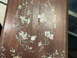 a wooden cabinet with a floral design on it