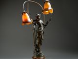 an image of a lamp that has a statue on top of it