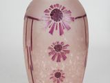 a pink glass vase with a flower design on it