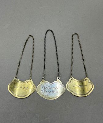 three silver and gold plated necklaces with the names of three people