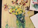 three paintings of flowers in a vase on a table