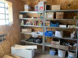 a room that has a lot of shelves and bins in it