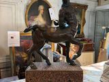a statue of a man riding a horse on a table