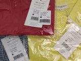 three men ' s shirts in different colors and sizes on a table