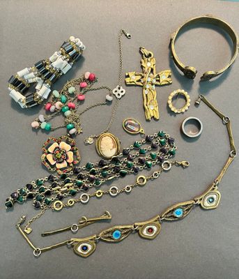 a lot of jewelry that is laying out on the table