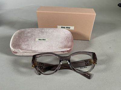 sunglasses and case sitting on a table next to a box