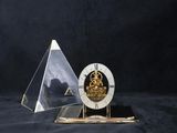 a clock that is sitting on a table next to a pyramid