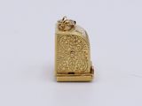a close up of a small gold clock on a white surface