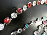 a close up of a necklace with many different colored beads