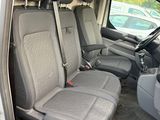 the interior of a van with four rows of seats and a steering wheel