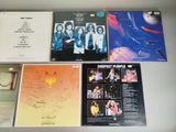 various cd ' s and cds are on a table in a display case