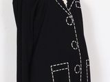 an image of a mannequin mannequin wearing a black sweater with white stitching