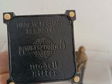a person holding a small black plaque in their hand
