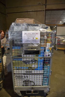 a cart full of cans and cans of beer in a warehouse