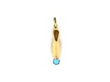 a close up of a gold pendant with a blue stone