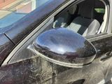 a black car with a mirror on the side of it