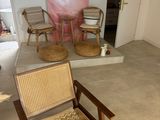 a chair and a table in a room with a painting on the wall